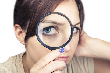 girl with magnifying glass over her face