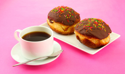 Tasty donuts on color plate on color background