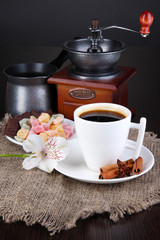 White cup of Turkish coffee with rahat delight, coffee pot and