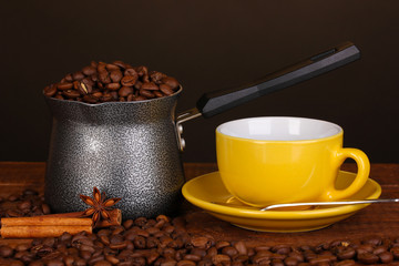 Coffee maker with yellow cup on wooden table