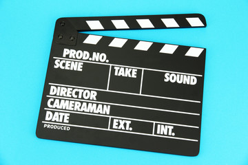 Fototapeta premium Movie production clapper board on color background