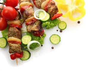 tasty grilled meat and vegetables on skewers, isolated on white