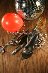 Party shoes on floor with champagne glass