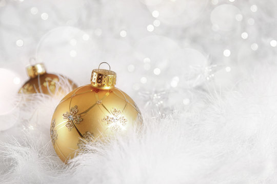 Golden Christmas balls on holiday background