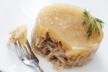 meat in aspic on white plate closeup