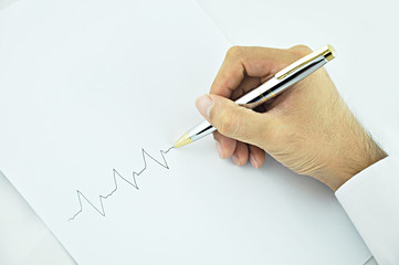 Hand writing pulse line on white paper