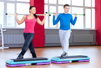 Man and woman at the gym doing stretching