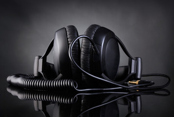 Modern headphones over dark background