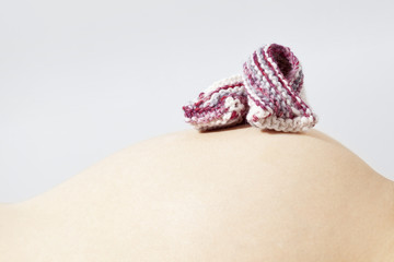 Pregnant woman and baby booties