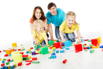 Happy family. Parents with three kids playing blocks over white