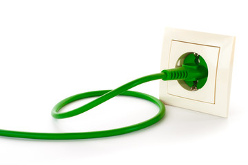 Green power plug into power outlet