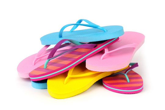Pile of Colorful Flip Flops Isolated on White