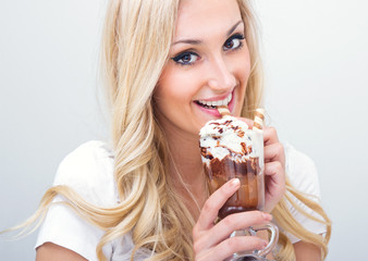 Young woman drinking ice coffe, studio-shot