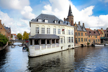Panorama of Bruges. Houses reflected in channel water.