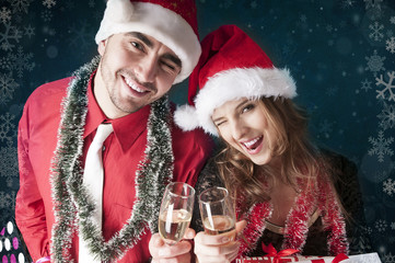 Happy Christmas couple with glasses of champagne