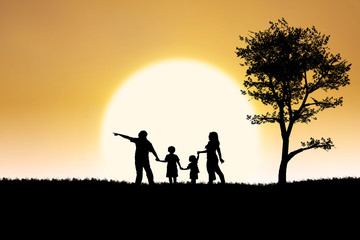 Fototapeta na wymiar Family silhouette of on sunset and tree background