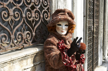 Person in Venetian costume attends the Carnival of Venice.