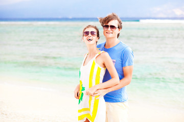 young happy couple having fun on tropical beach. honeymoon