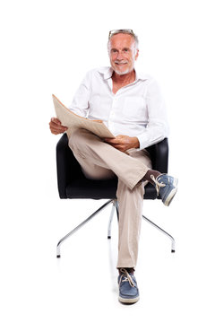 Casual senior man reading stock rates in newspaper 3