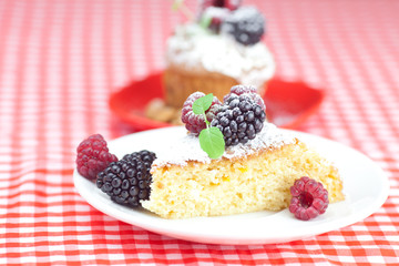 muffin with whipped cream, cake with icing, raspberry, blackberr