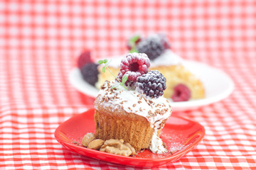 muffin with whipped cream, cake with icing, raspberry, blackberr