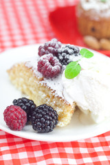 cake with icing,icecream, raspberry, blackberry and mint on a pl