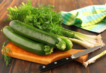Zucchini, green onion and dill on cutting board