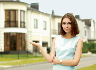 Young woman standing near house, isolated on white background