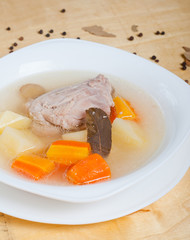 plain chicken soup with vegetables on it