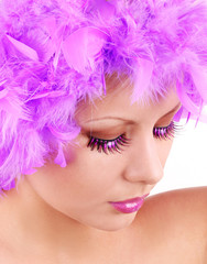 fashion makeup with shiny eyelashes and purple feathers
