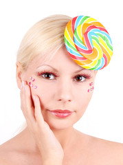 portrait of blonde young girl with lollipop fashion makeup