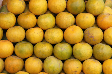 Plenty of tangerines, for sale on a market stall in Thailand.