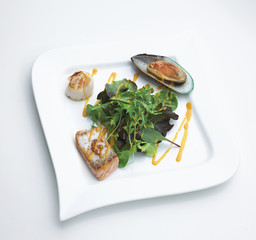 Seafood steak serves with salmon mussel scallops and vegetables