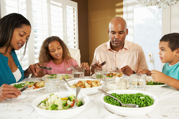 Family Enjoying Meal At Home