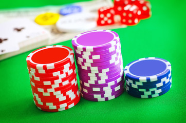 Group from chips for poker on the green background