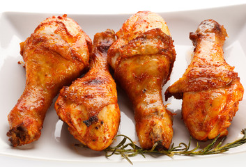 Grilled chicken legs on white background