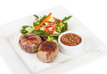 Grilled steak wrapped in bacon, with grilled vegetables, mashed