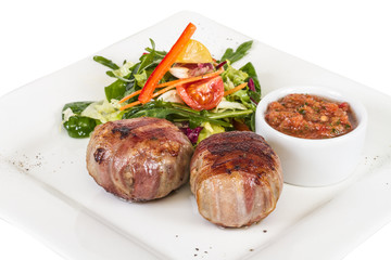 Grilled steak wrapped in bacon, with grilled vegetables, mashed