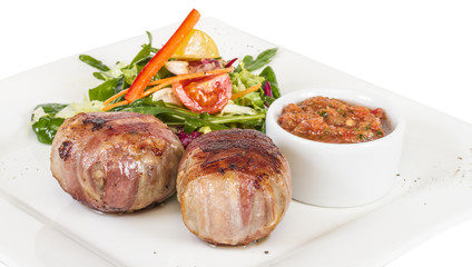 Grilled steak wrapped in bacon, with grilled vegetables, mashed