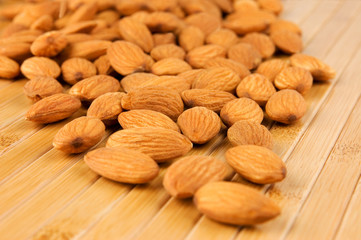 Raw almonds on bamboo