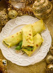 pesto crepes over golden christmas table