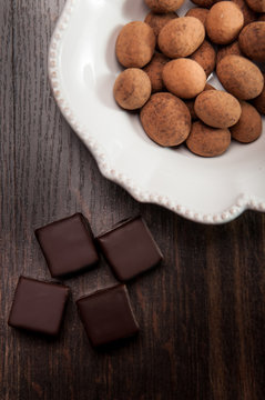 Chocolate pralines on daerk wooden background