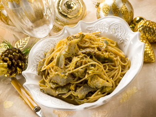 spaghetti carbonara with artichoke on christmas table