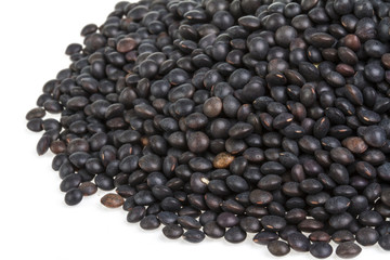 Heap of black lentil isolated on white
