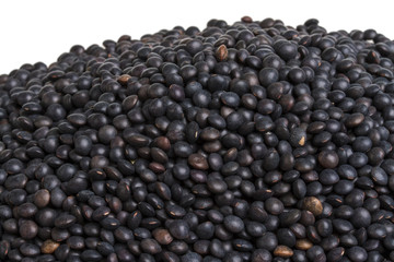 Heap of black lentil isolated on white