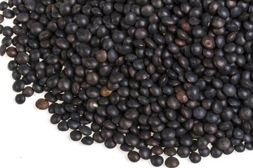 Heap of black lentil isolated on white
