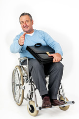 Friendly man in wheelchair holding thumbs up