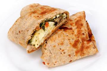 Feta Egg Wrap Close Up on White Plate Cut in Halves © Ixepop