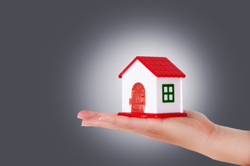 Woman hands holding house