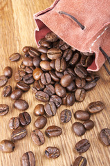 coffee beans are scattered on wooden background